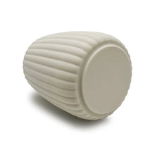 Beige ribbed rubberized plastic toothbrush holder, end view