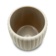 Beige ribbed rubberized plastic toothbrush holder with open interior