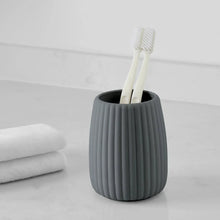 Grey ribbed toothbrush holder with two toothbrushes