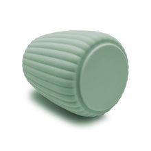 Green ribbed plastic toothbrush holder, end view with rounded base