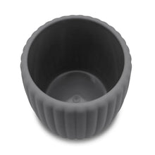Grey ribbed toothbrush holder with dark interior and smooth inner base