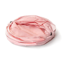Pink pop-up spiral laundry hamper opened wide, showing inner lining folds