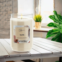 Vanilla scented glass jar candle with lit single wick in clear glass jar