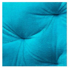 Blue upholstered fabric close-up with tufted stitching on a folding butterfly chair