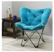 Blue folding butterfly chair with tufted back, padded seat, and metal folding legs