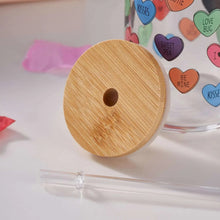 Wooden sipper lid with center hole and clear straw, heart-print glass jar