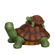 Garden turtle figurine with baby turtle on top, green body and orange-brown shell