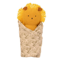 Plush lion baby rattle in leaf-pattern cotton burp cloth, front view