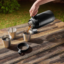 Manna 64oz stack jug in black with screw lid, handle, and stainless cups