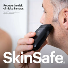 Black foil face shaver held against side of face