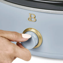 Light blue slow cooker dial showing Warm, High, and Low labels