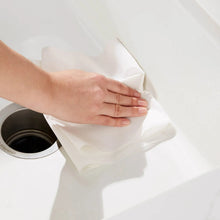 White paper towel sheet dispensed from a dispenser