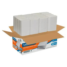 Open carton with folded white paper towels stacked in rows