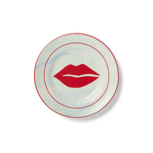 Round appetizer plate with red lip graphic and thin red rim