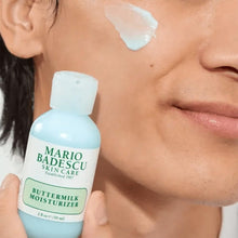 Mario Badescu Buttermilk Moisturizer bottle with cream dab on cheek