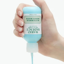 Mario Badescu Buttermilk Moisturizer bottle held in hand, blue cap