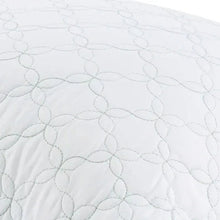 Close-up quilted trellis pattern on light white pillow cover with loop stitching