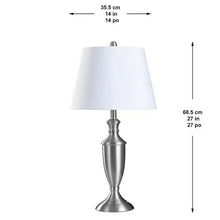 Table lamp with white drum shade and silver tiered pedestal base