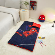 Kids slumber bag on bed with squishy pillow, red and navy Spider-themed design