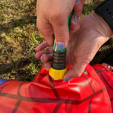Red inflatable sprinkler valve and hose connector in hands