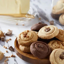 Assorted shortbread cookies on a round wooden plate