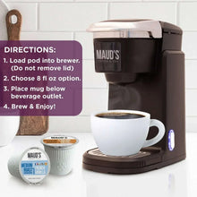 Coffee brewer with a cup and two pods from the medium roast variety pack