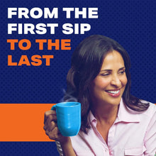 K-Cup coffee mug with dark brew, held by a person in a blue cup