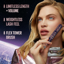 Mascara wand held near eye with lifted lashes on a blonde model