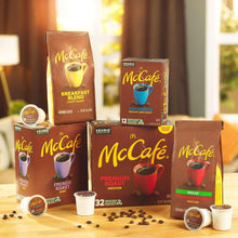 McCafe K-Cup pod variety boxes with French Roast dark pods and coffee cups on table