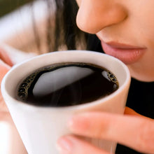 K-Cup coffee pod with dark roast coffee in a white cup