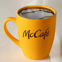 McCafe coffee in a yellow mug with crema on top