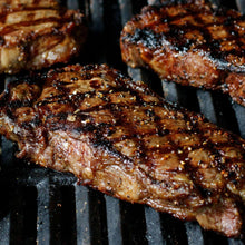 Grilled beef steaks covered with coarse Montreal Steak spice seasoning
