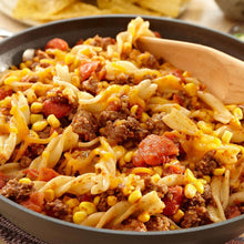 Skillet taco filling with seasoned ground beef, corn, tomatoes, and shredded cheese