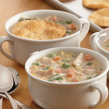 Poultry gravy in white bowls with biscuits