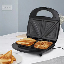 Electric sandwich maker with nonstick plates open, heating toast halves