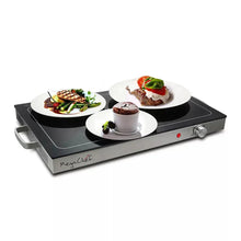 Electric warming tray with plated meals on black warming surface and large control knob