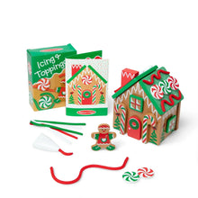Wooden gingerbread house play set with red and green candy decorations and tools