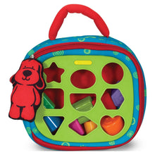 Take-Along shape sorter activity bag with green panel and circular shape holes