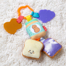 Multicolor clip-on sensory infant toy with bread slice, purple flower tag, and waffle heart pieces