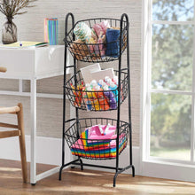 3-tier black wire basket stand with baskets holding folded cloths and colorful items