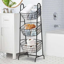 3-tier black wire basket stand with top basket holding folded towels and two lower baskets