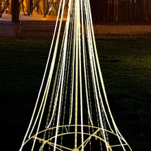Pre-lit shooting star tree with warm white light strands and circular base frame