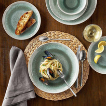 Green speckled dinnerware plate with bowl, featuring pasta and seafood on top
