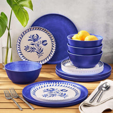 Cobalt dinnerware set with patterned plates, stackable bowls, and serving dish