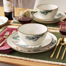 Stoneware bowl and saucer set with evergreen and red-berry rim pattern