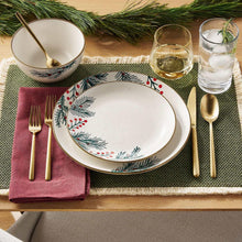 Holiday stoneware dinnerware with patterned dinner plate, matching bowl, and gold utensils