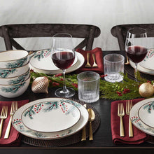 Holiday stoneware dinnerware set with plates and bowls, paired with gold cutlery