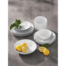 White porcelain dinnerware set with stacked plates, bowls, and cups