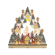 Pre-lit village holiday scene decoration with glowing windows, conifer trees, and lantern posts