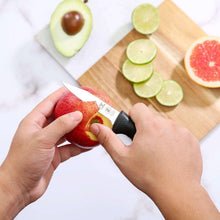 Paring knife with black handle cutting watermelon with lime slices nearby